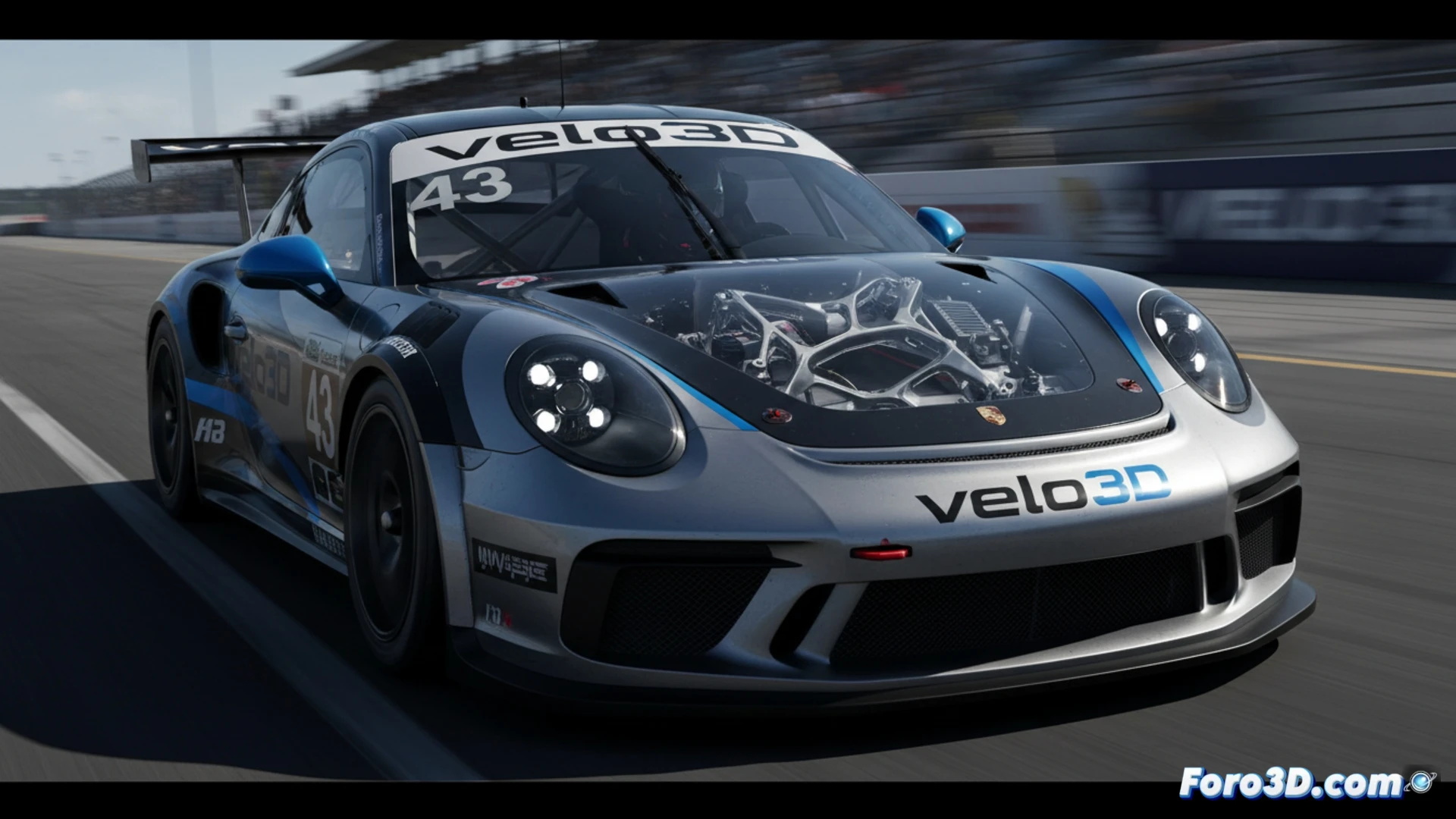 Descripción para imagen (80-120 caracteres, sin comillas dobles):

Imagen de un Porsche No. 43 de Andretti en pista, con piezas metálicas impresas en 3D de Velo3D visibles en el montaje de aluminio del motor.