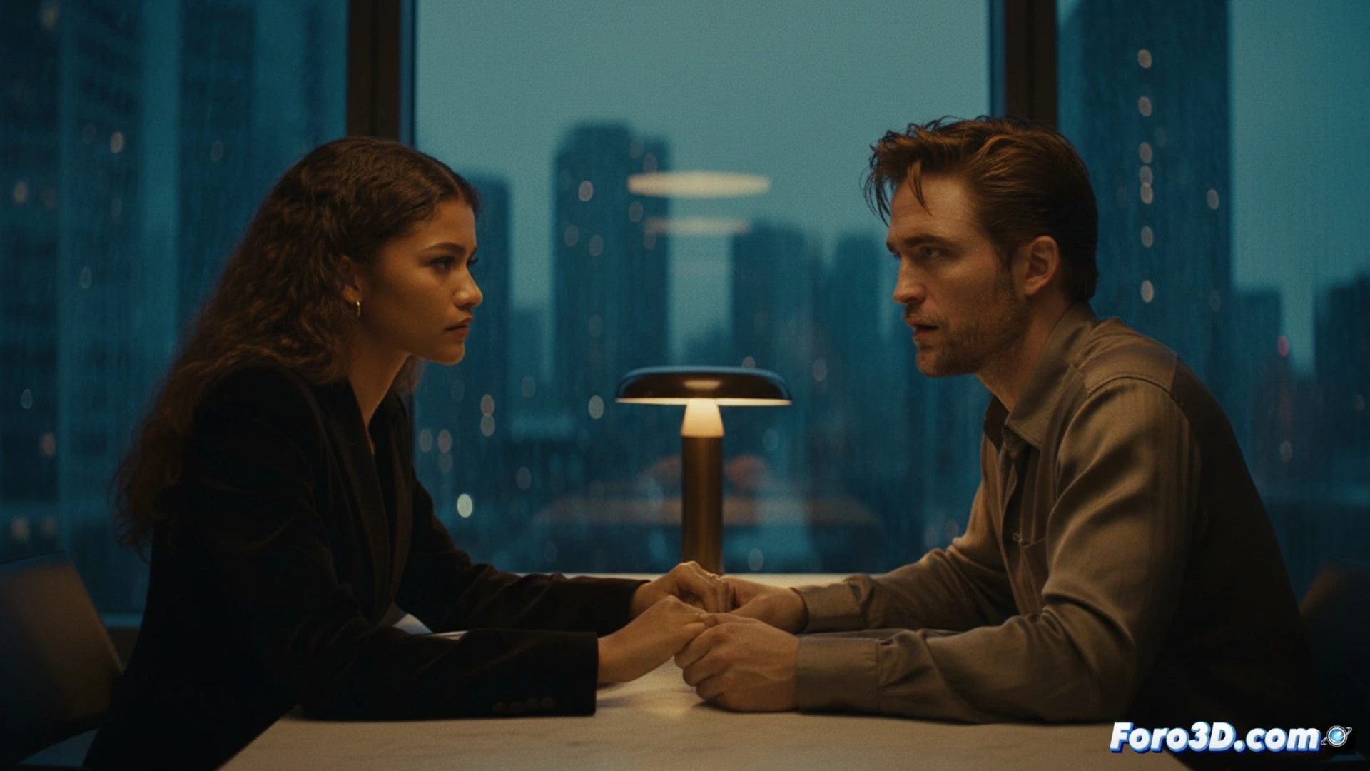 Zendaya y Robert Pattinson en un plano simetrico, reflejados en espejos y pantallas de previsualizacion 3D.